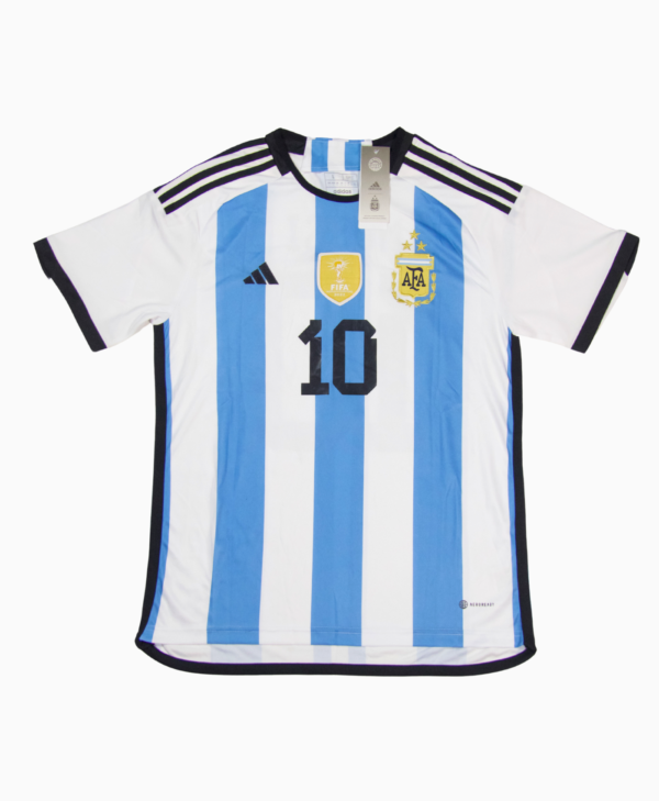 Imagen de la camiseta local de la selección argentina para la temporada 2023-2024, vista frontal, con el jugador Lionel Messi.