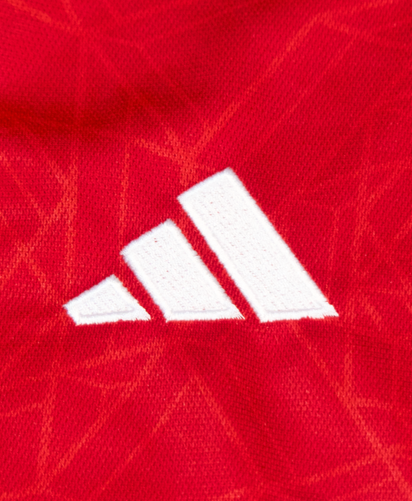 Imagen del detalle del icono de Adidas en la camiseta local del Manchester United para la temporada 2023-2024.